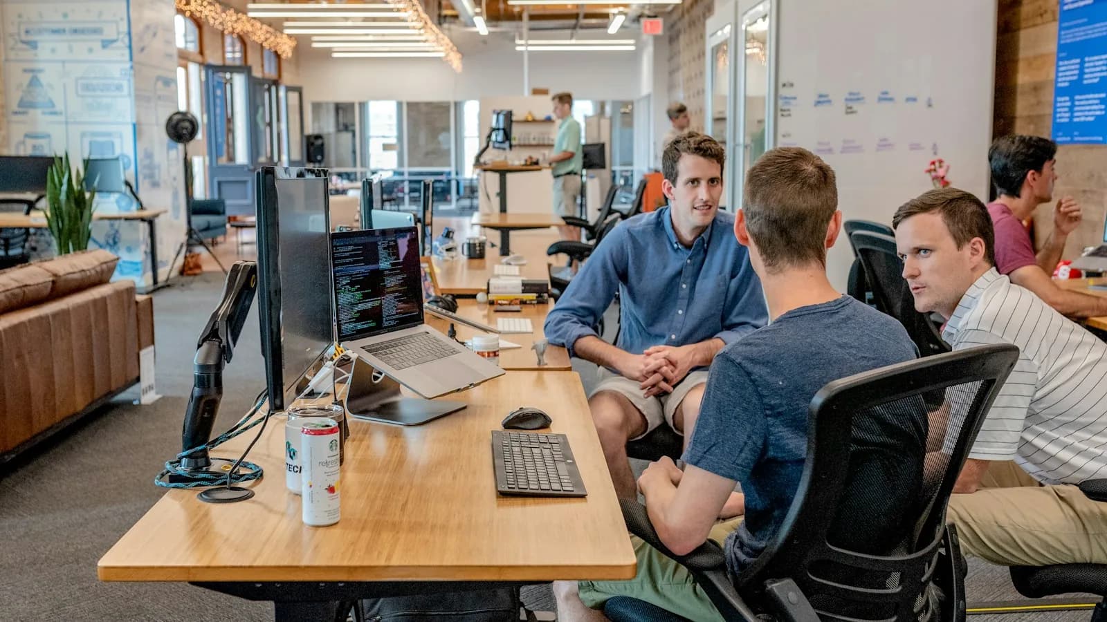 Lifecycle operations team reviewing an audience handoff before a one-time customer send, with the official Customer.io logo overlay