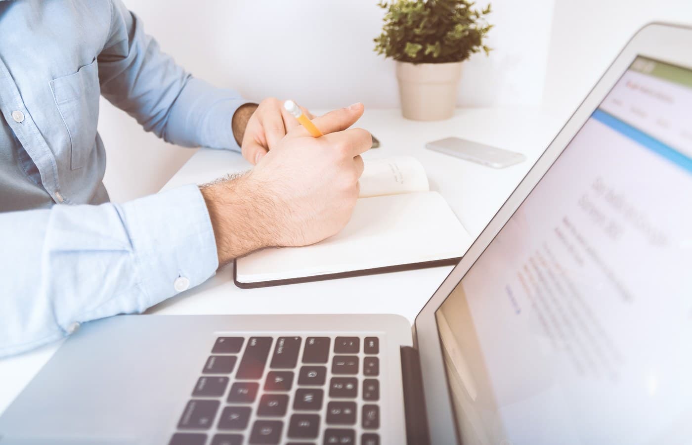 RevOps professional preparing notes beside a laptop before a customer follow-up review