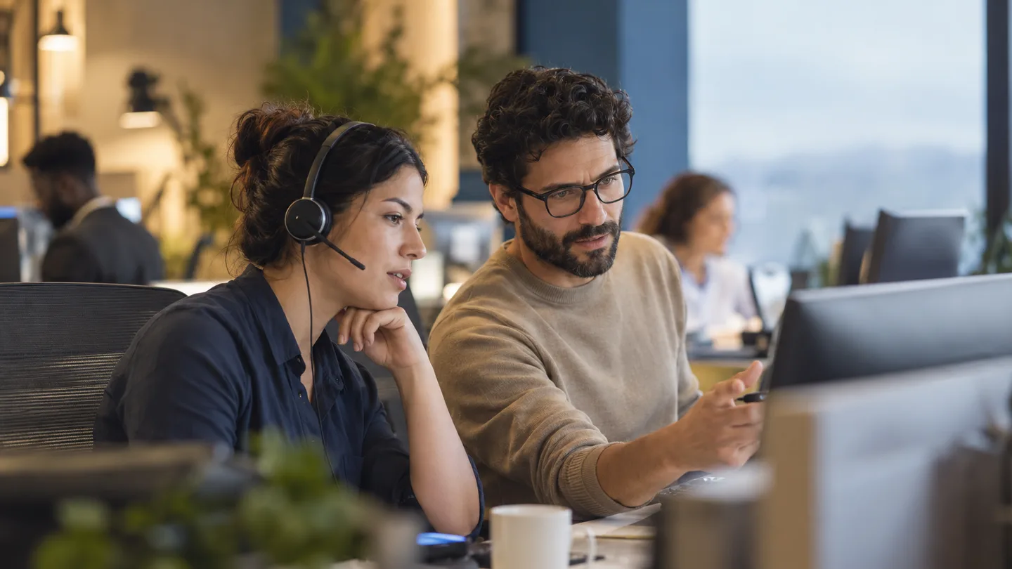 Editorial illustration of a support specialist and analyst reviewing a customer question.